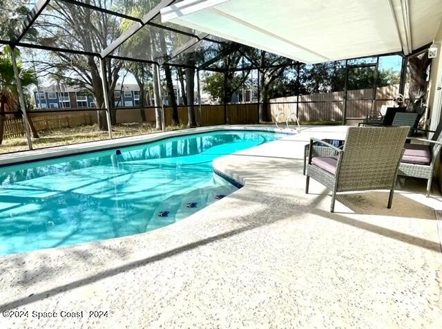 a view of a swimming pool with a lounge chairs