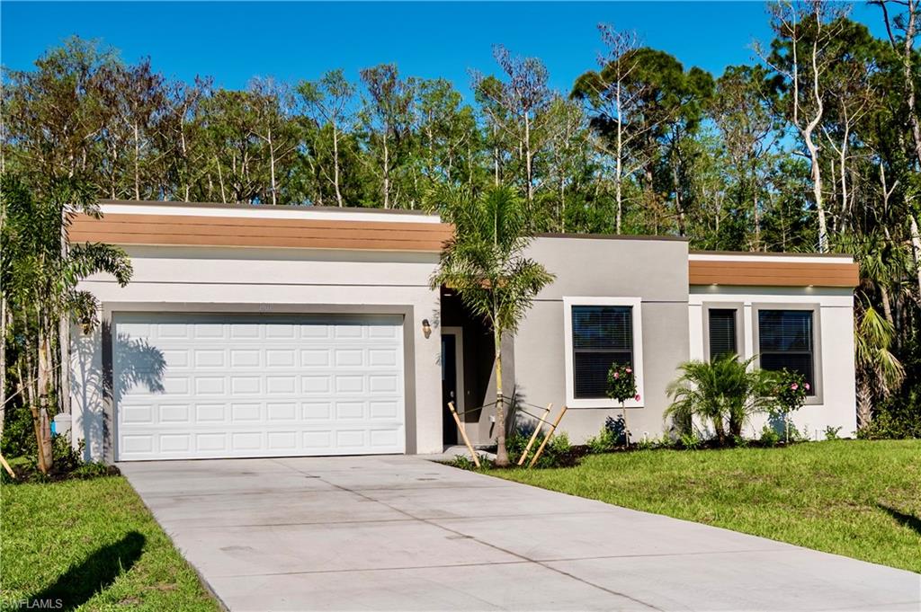 View of front of house featuring a front yard and a garage