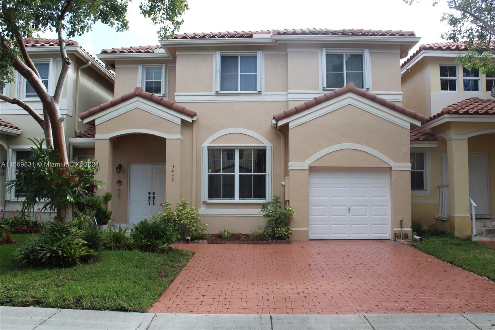 a front view of a house with a yard and garage