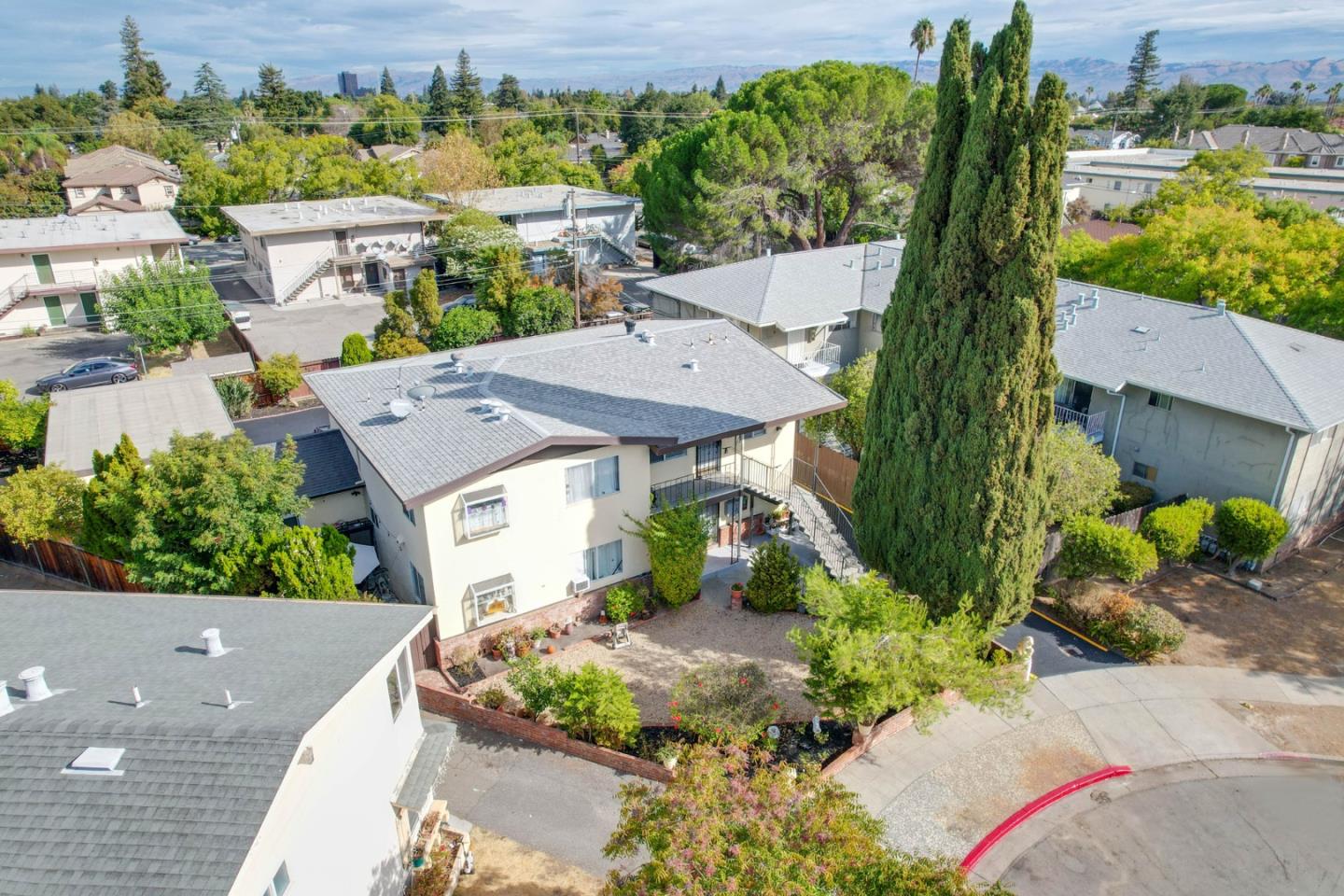 an aerial view of a house with a yard and potted plants