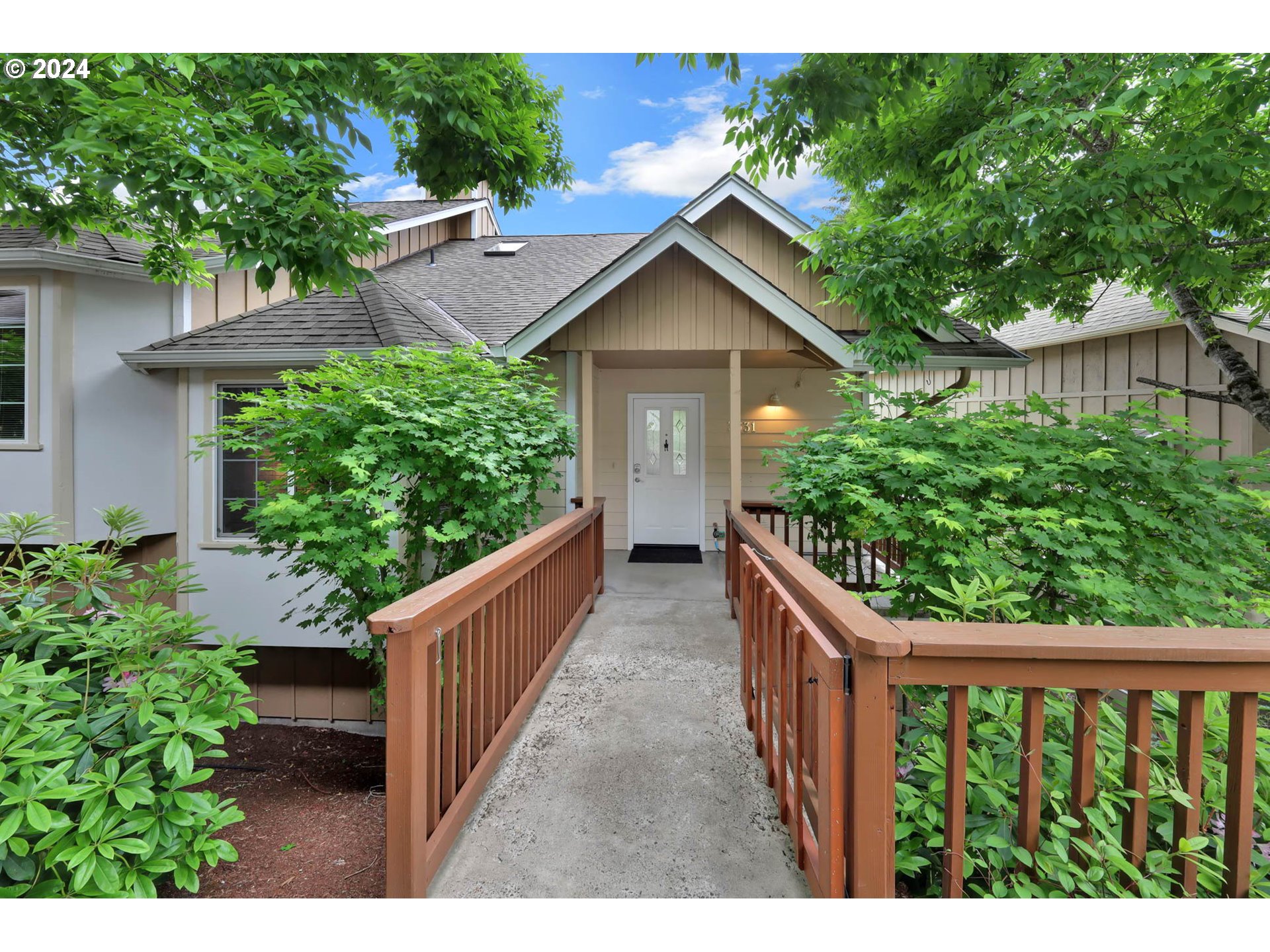 a view of a house with wooden fence