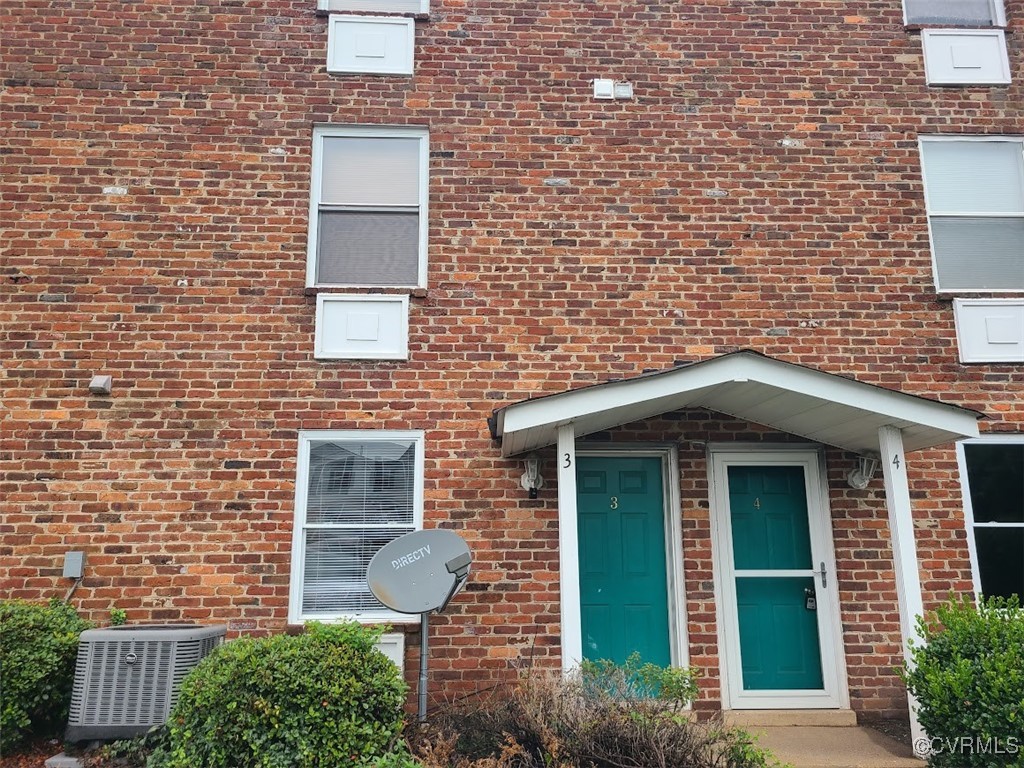 a view of a brick house with a large windows