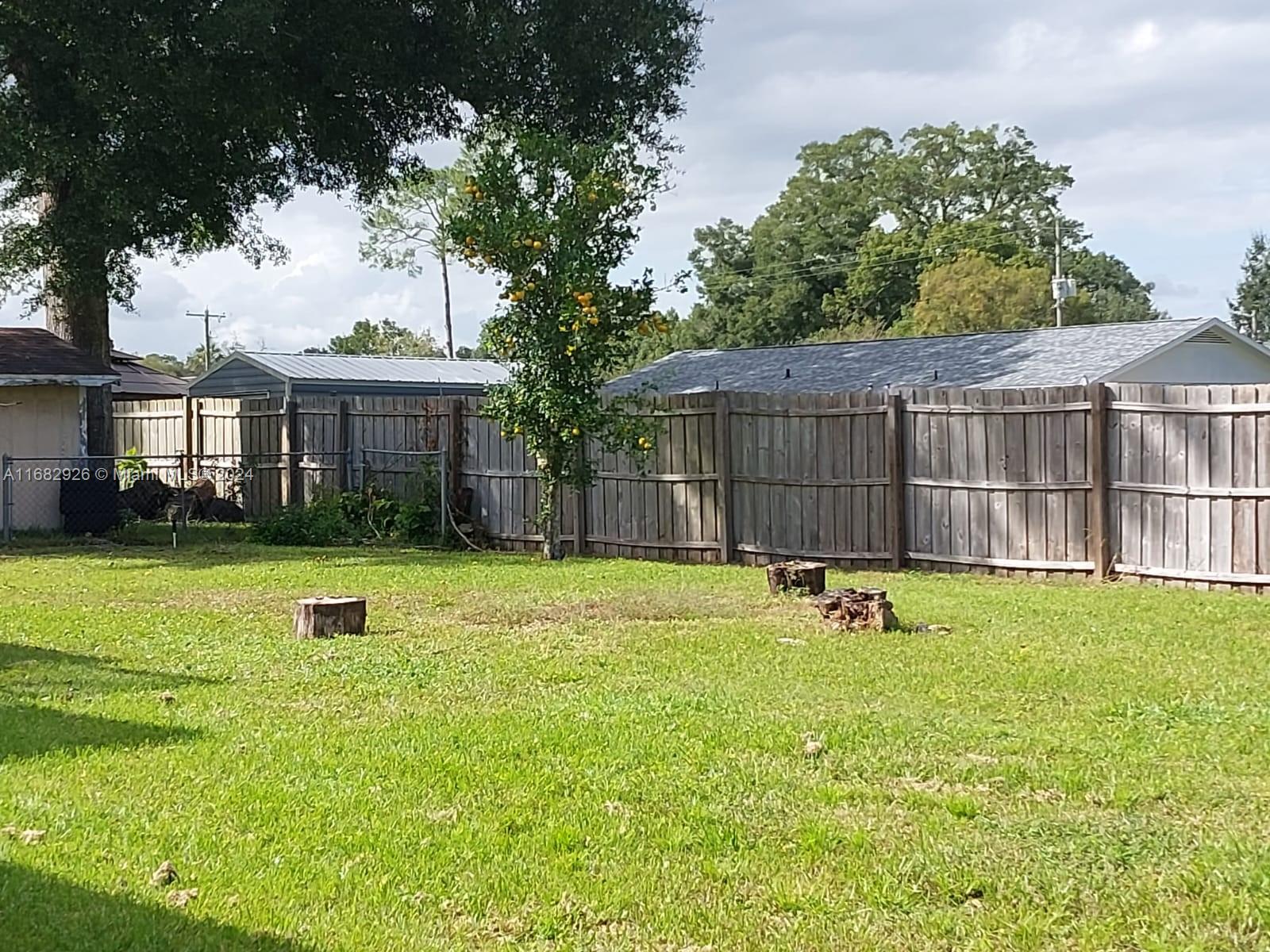 a view of a house with a backyard and a patio