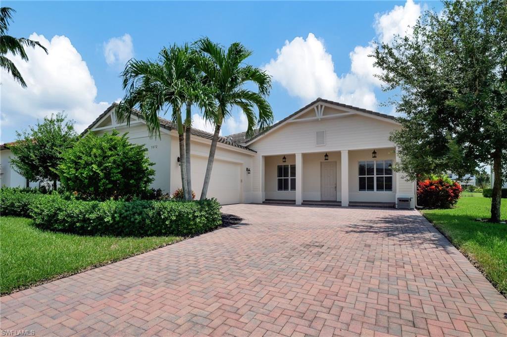 View of front facade with a front lawn and a garage