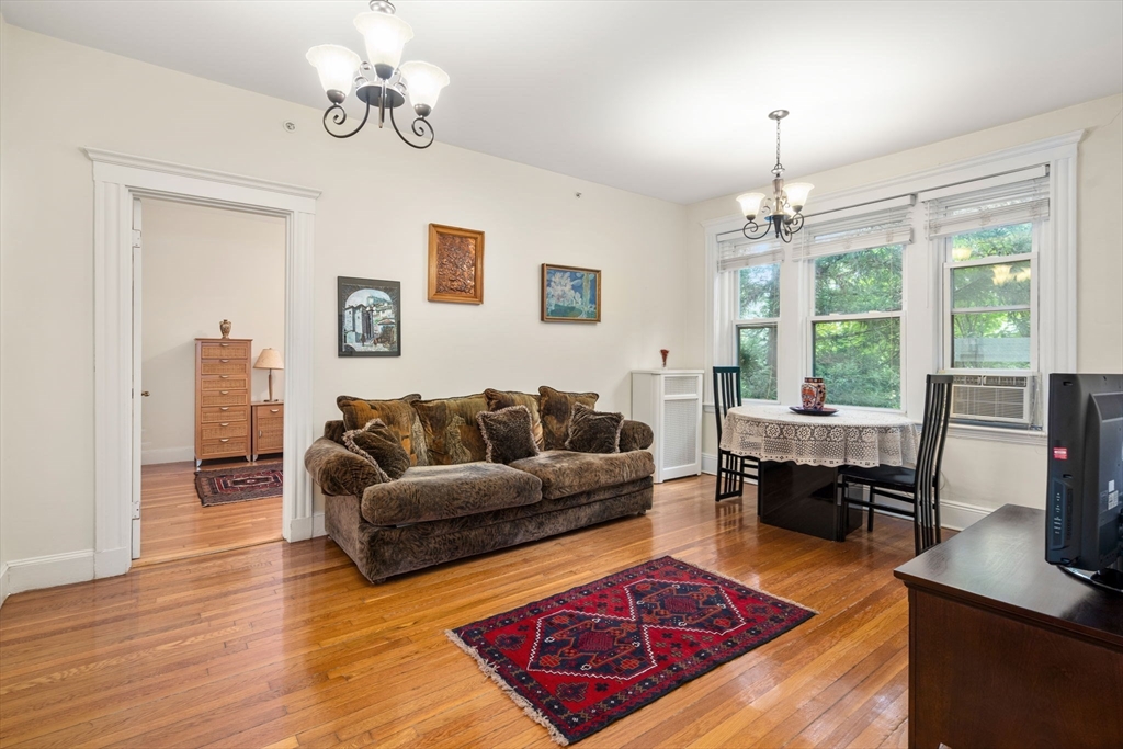 a living room with furniture a window and a chandelier