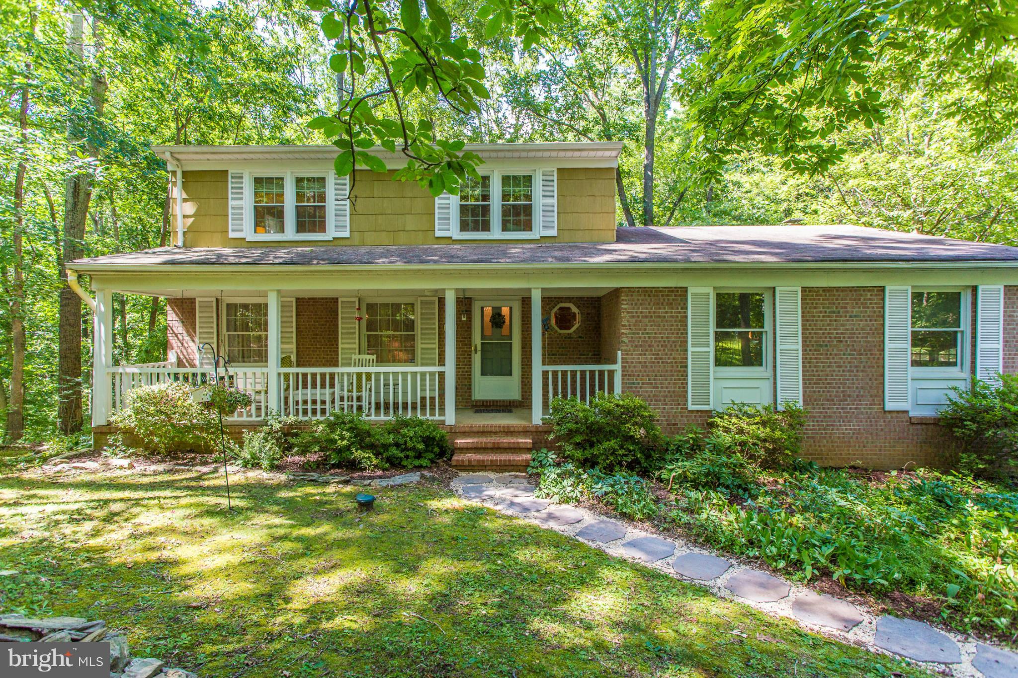 a front view of a house with garden and porch