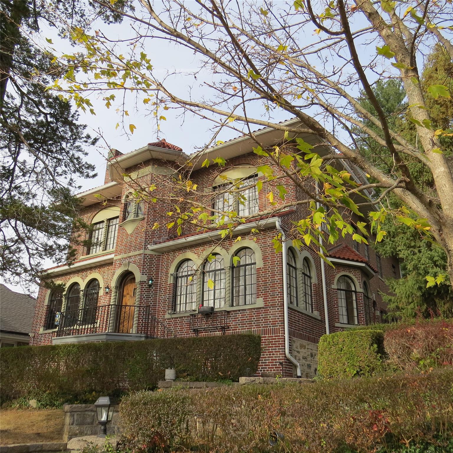 a front view of a house with parking plants