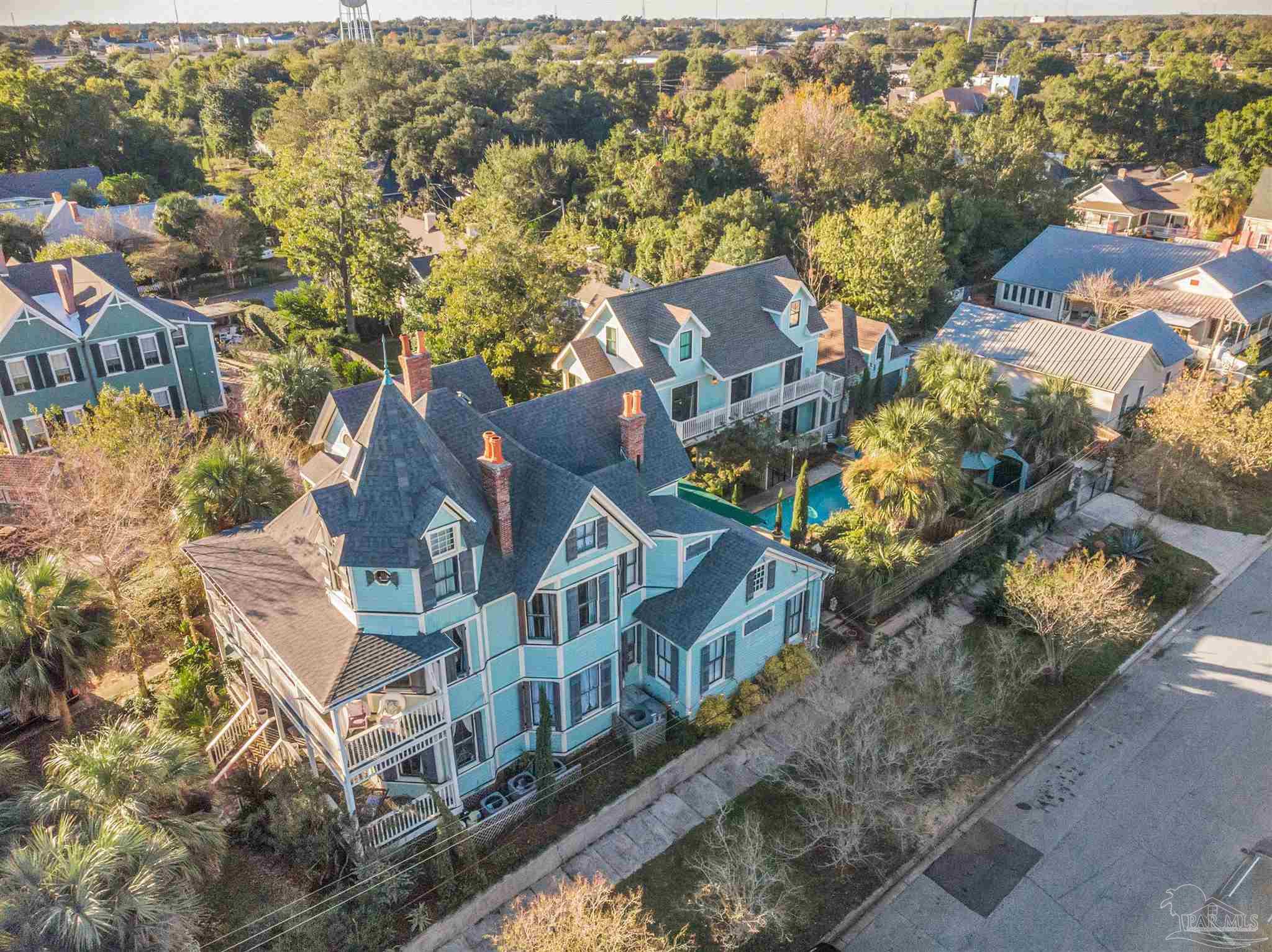 an aerial view of residential houses with yard