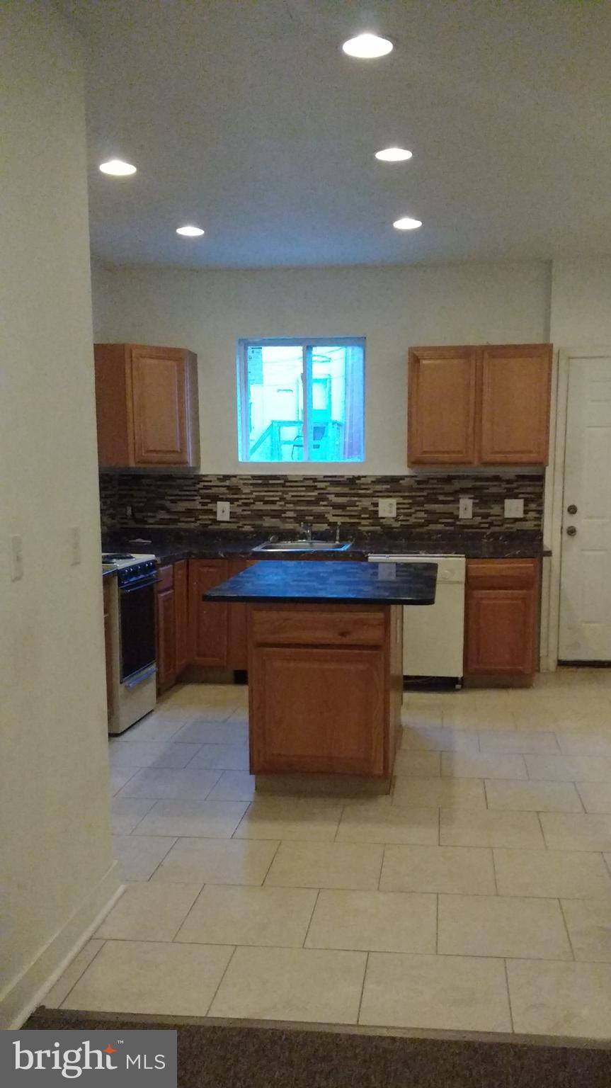 a kitchen with stainless steel appliances granite countertop a stove and a sink