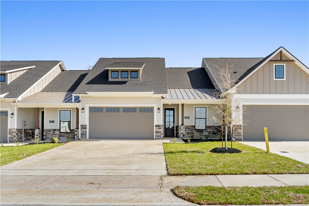 Craftsman inspired home featuring a garage and a f