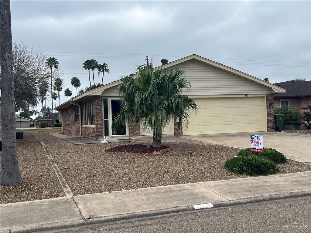 a view of a house with a yard and plants