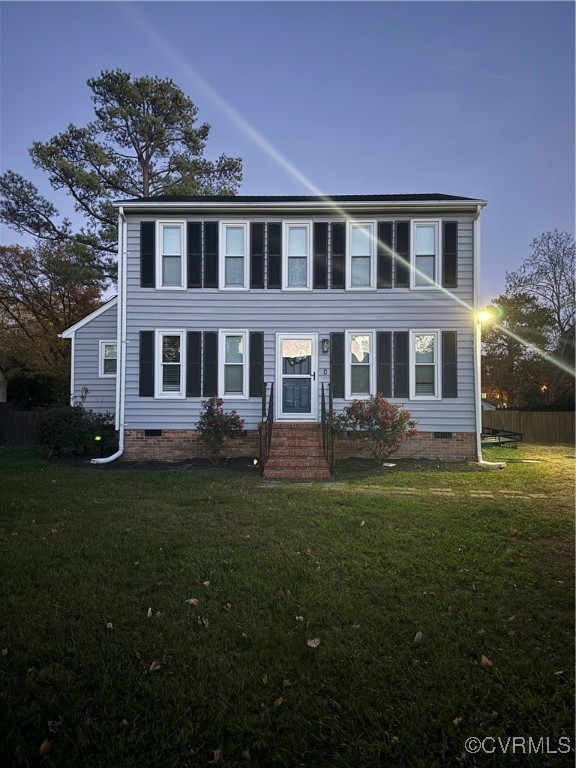 a front view of a house with garden and trees