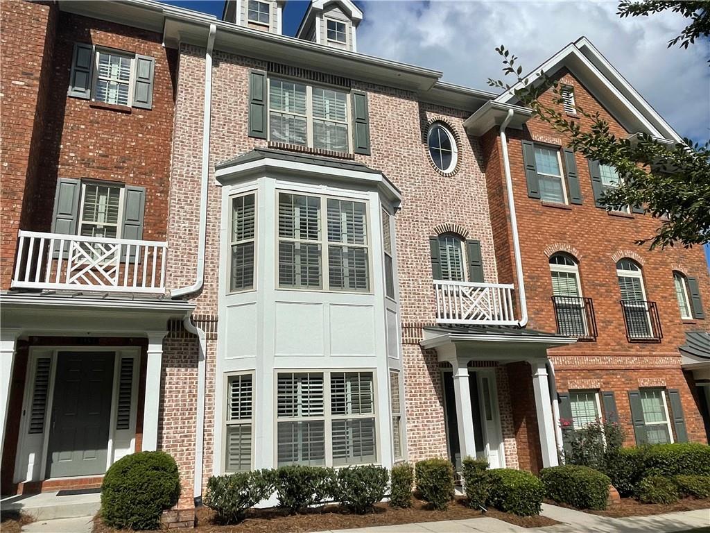 a front view of a residential apartment building with a yard