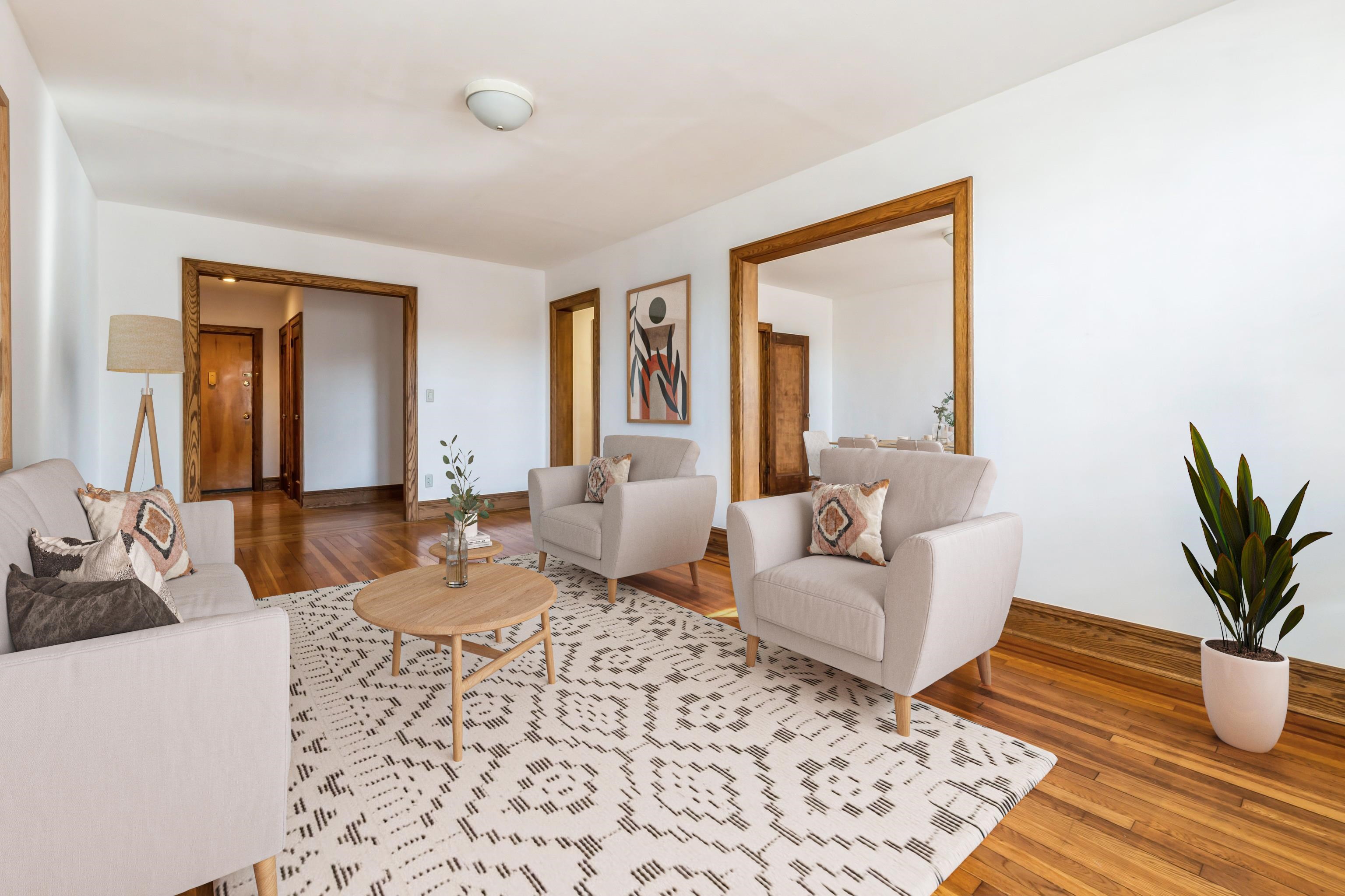 a living room with furniture and a potted plant