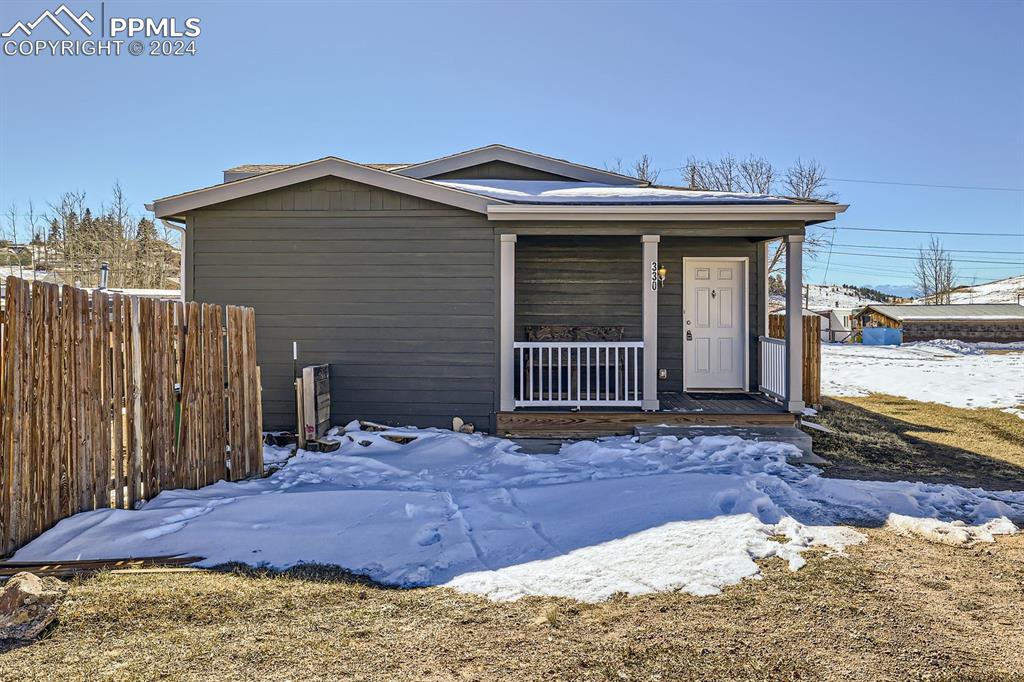 a view of a house with wooden fence