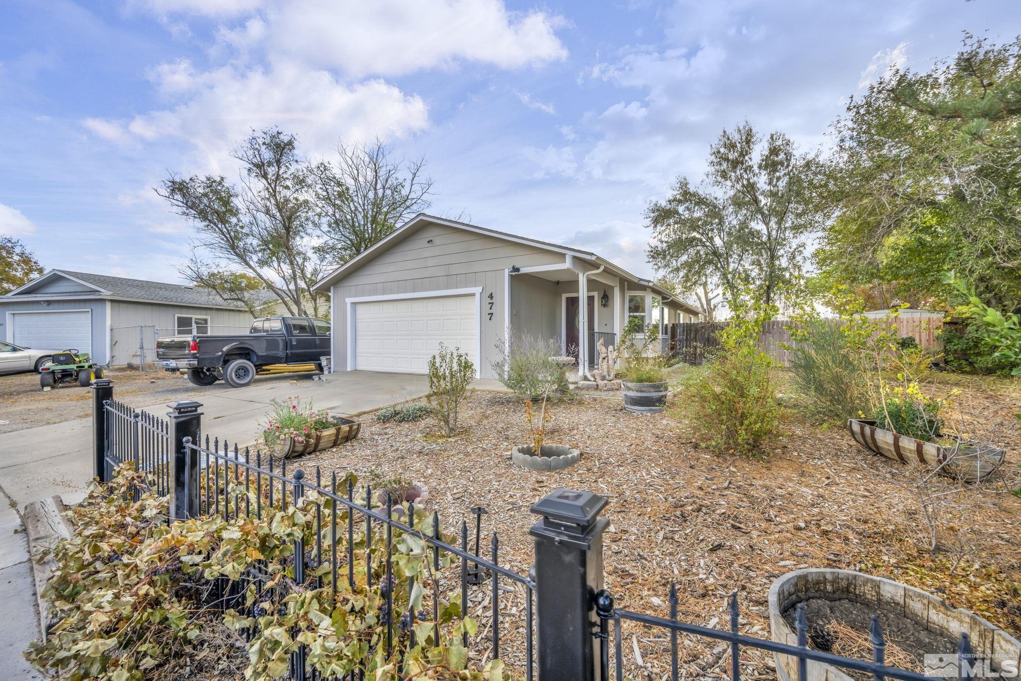 a view of a yard with a house and a tree