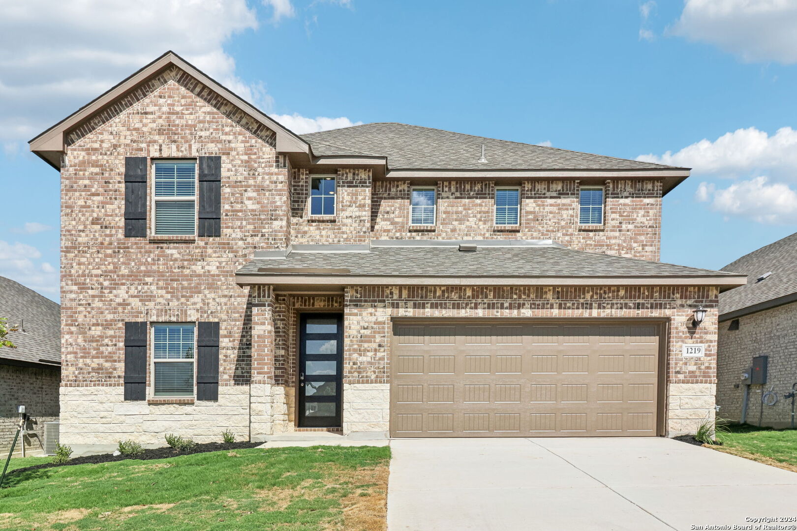 a front view of a house with a yard