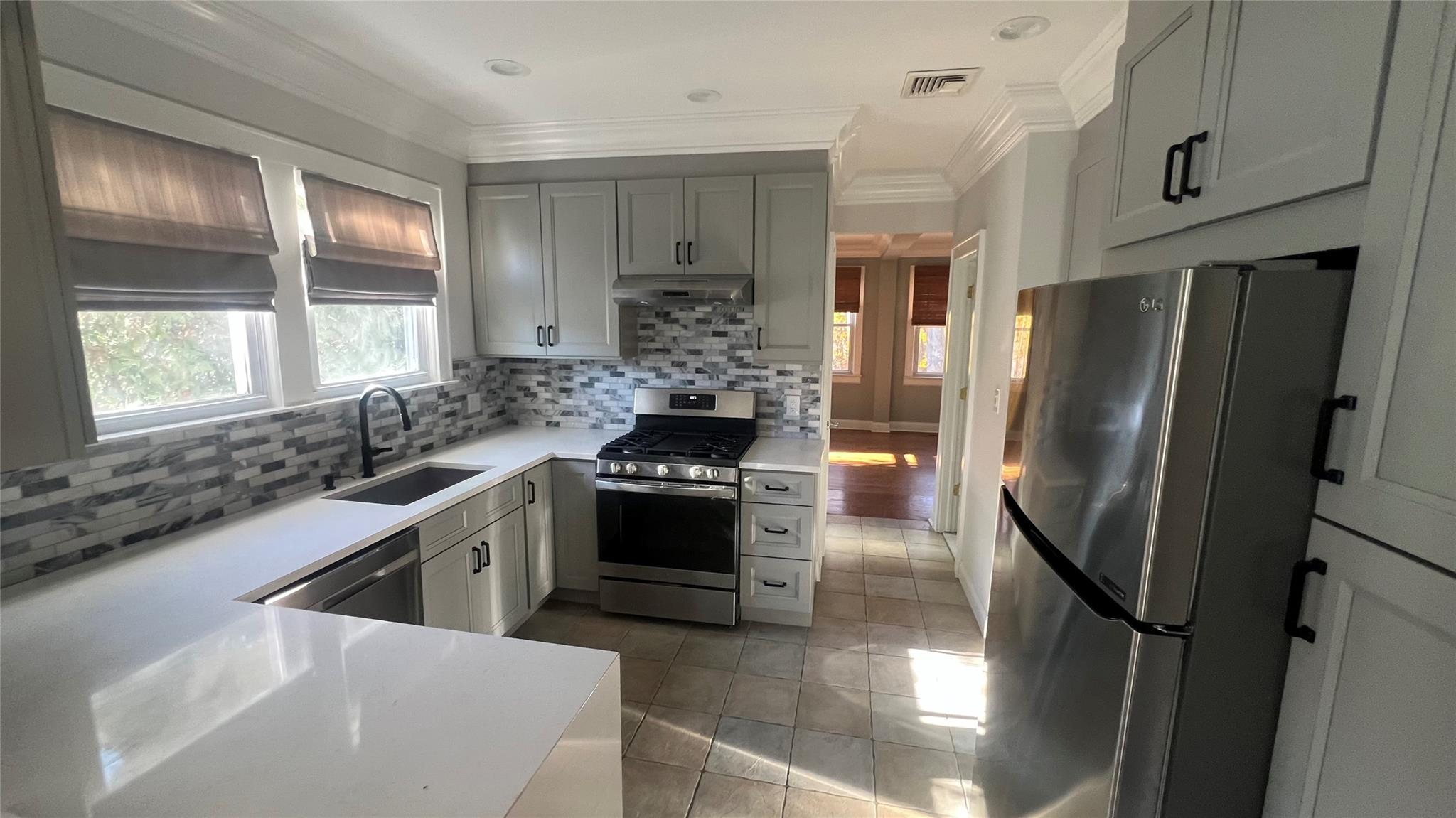 a kitchen with stainless steel appliances granite countertop a sink stove and refrigerator