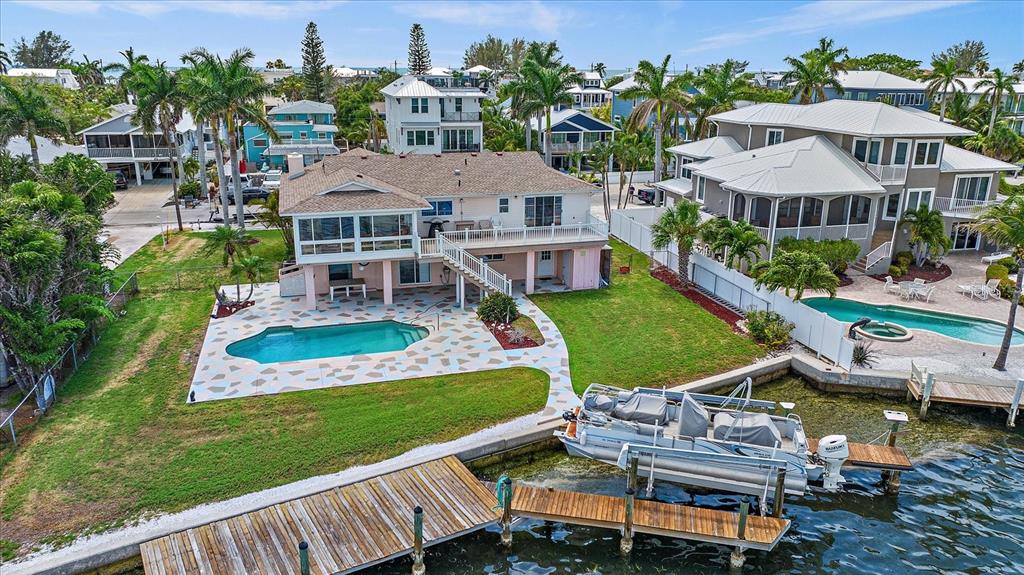 an aerial view of a house with swimming pool garden and patio