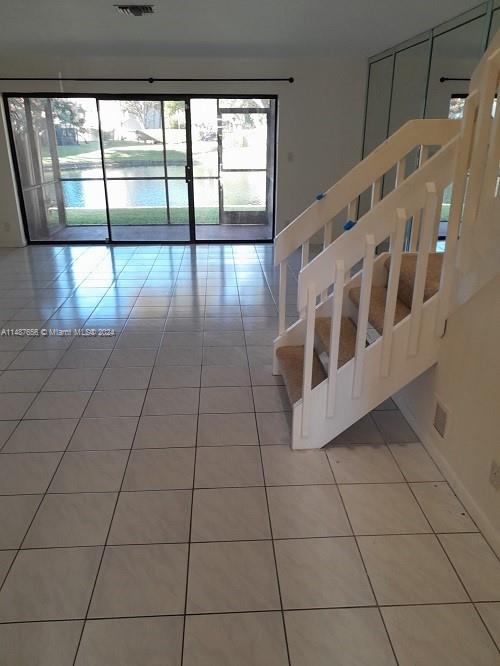 a view of an entryway with a floor to ceiling window