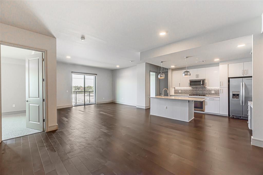 an open kitchen with white cabinets and stainless steel appliances