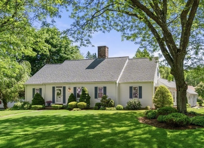 a front view of a house with a garden