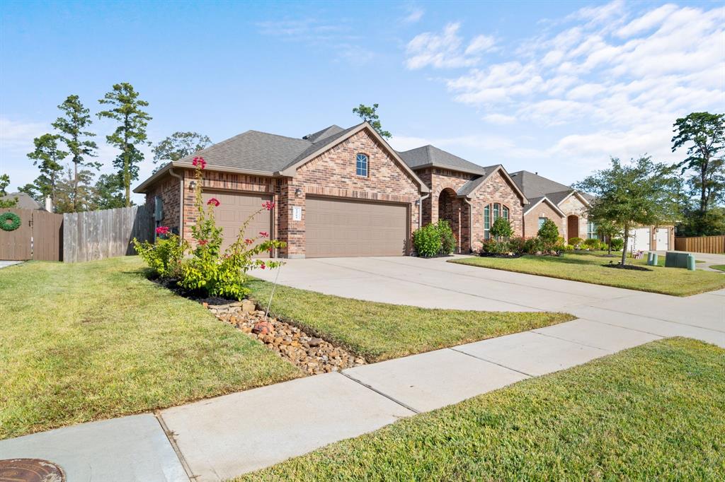 a front view of a house with a yard and trees