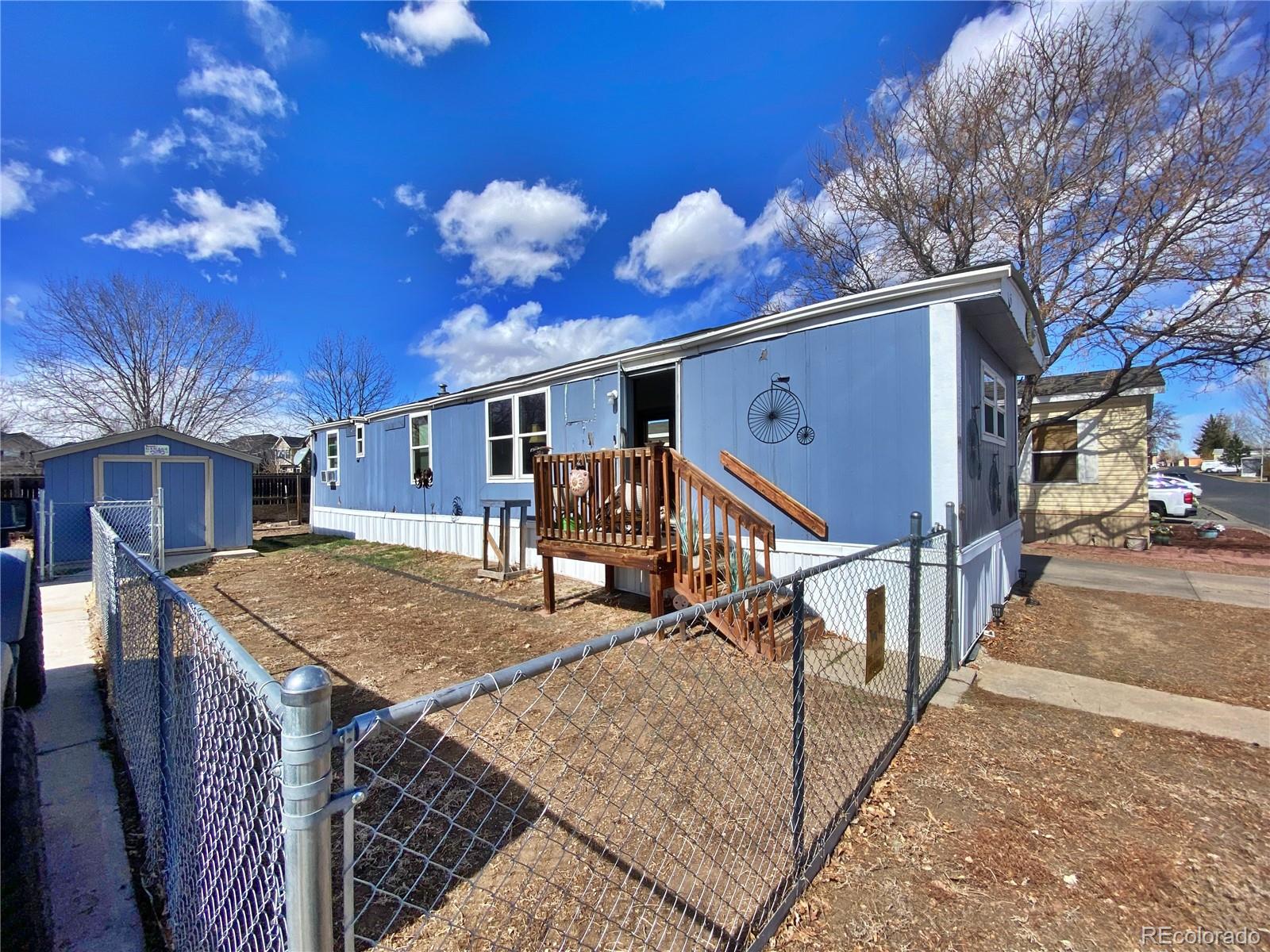 a view of a house with backyard and a tree