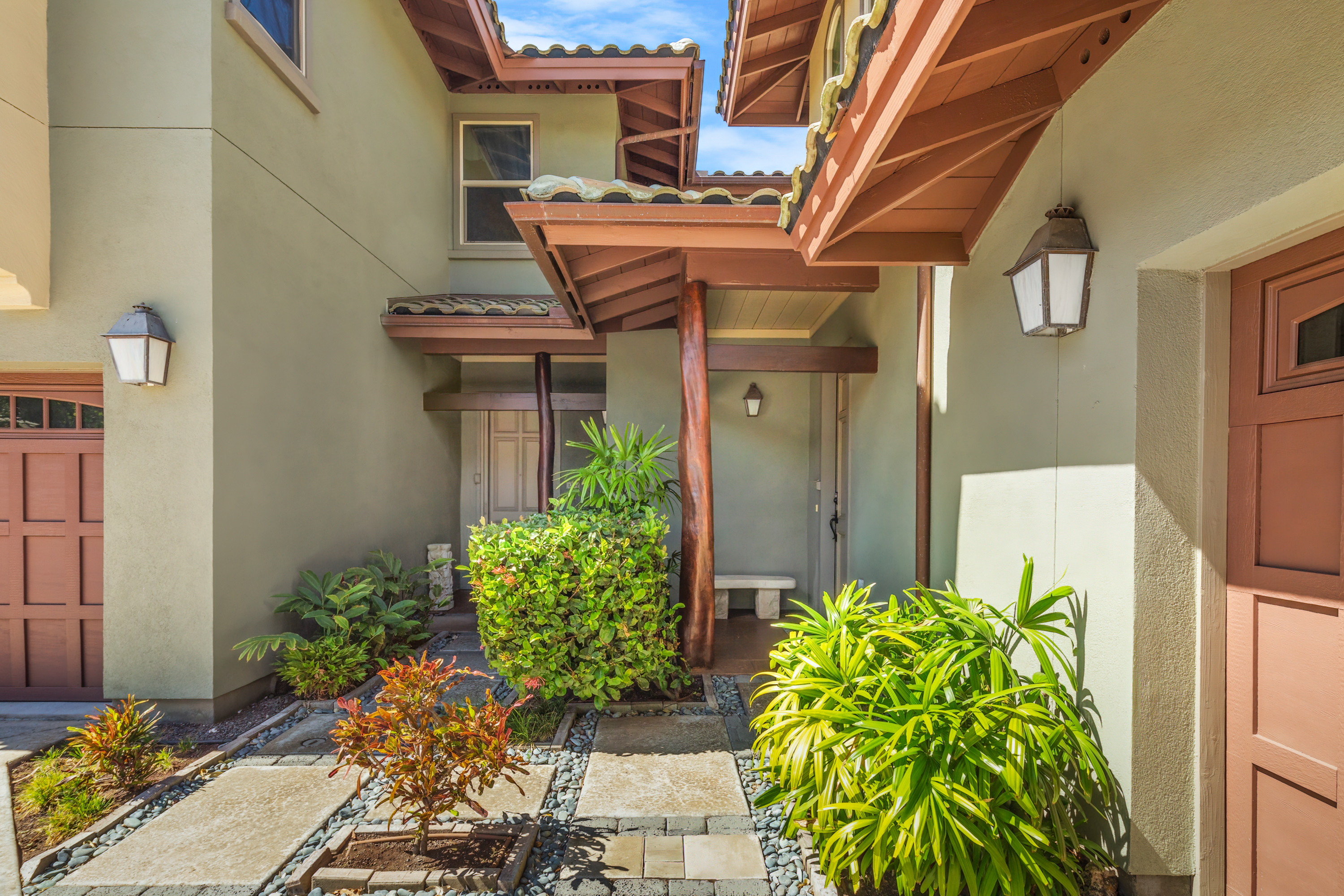 a view of a house with potted plants