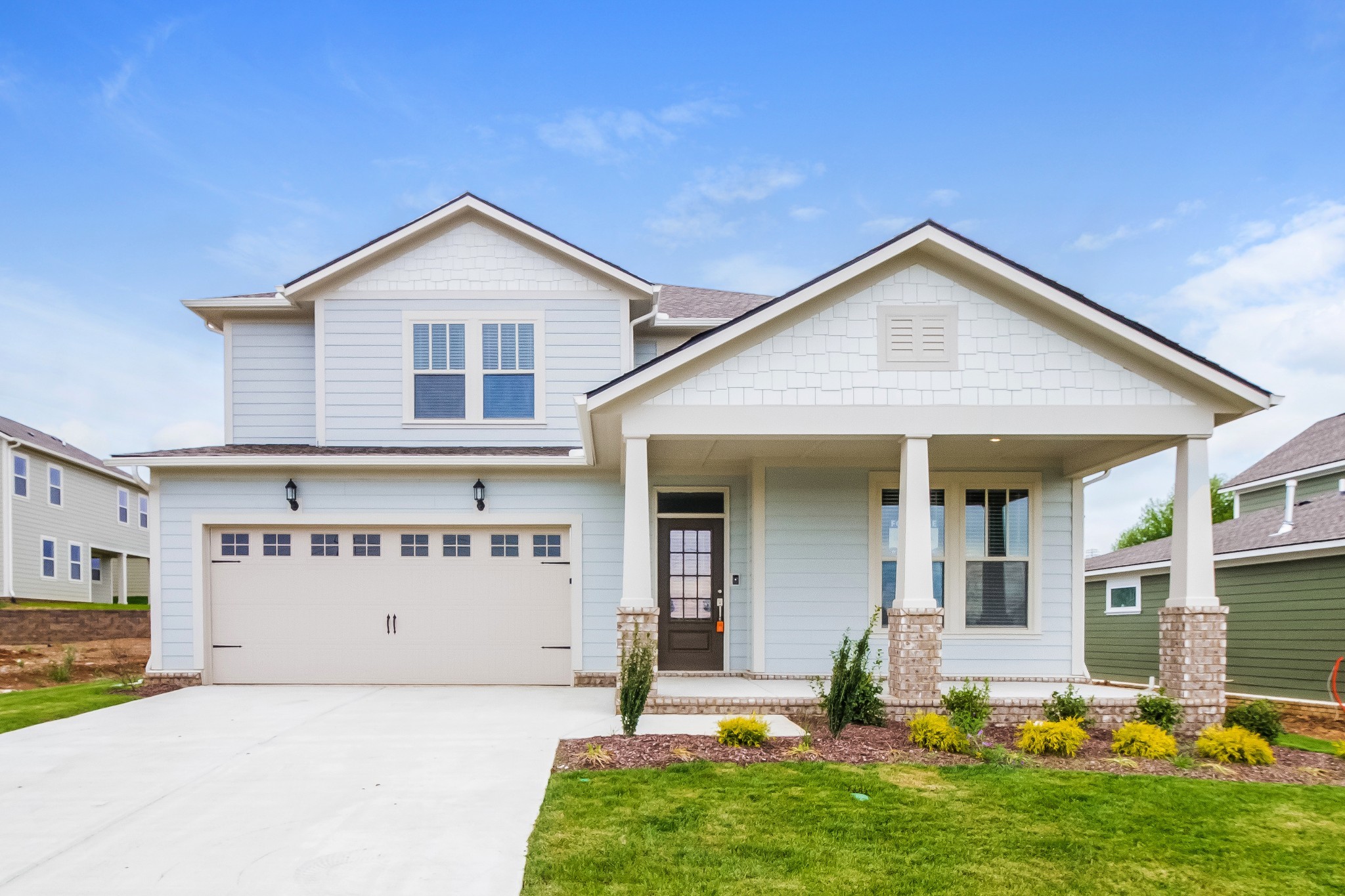 a front view of a house with a yard and garage