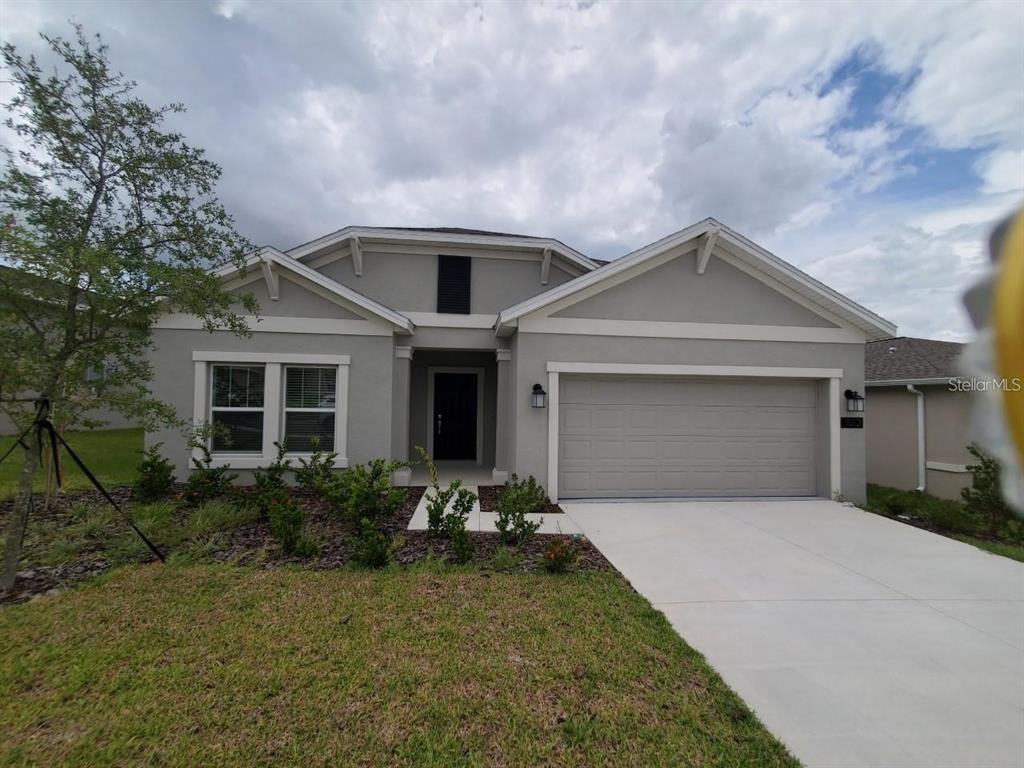 a front view of a house with a yard and garage