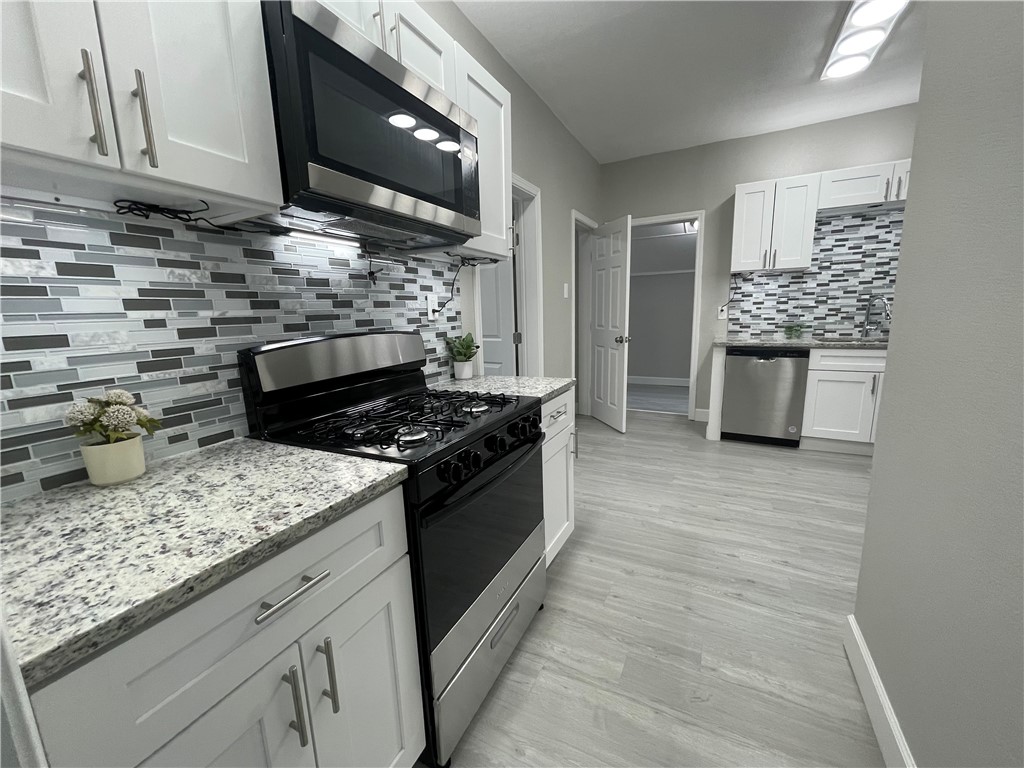 a kitchen with a stove and a microwave