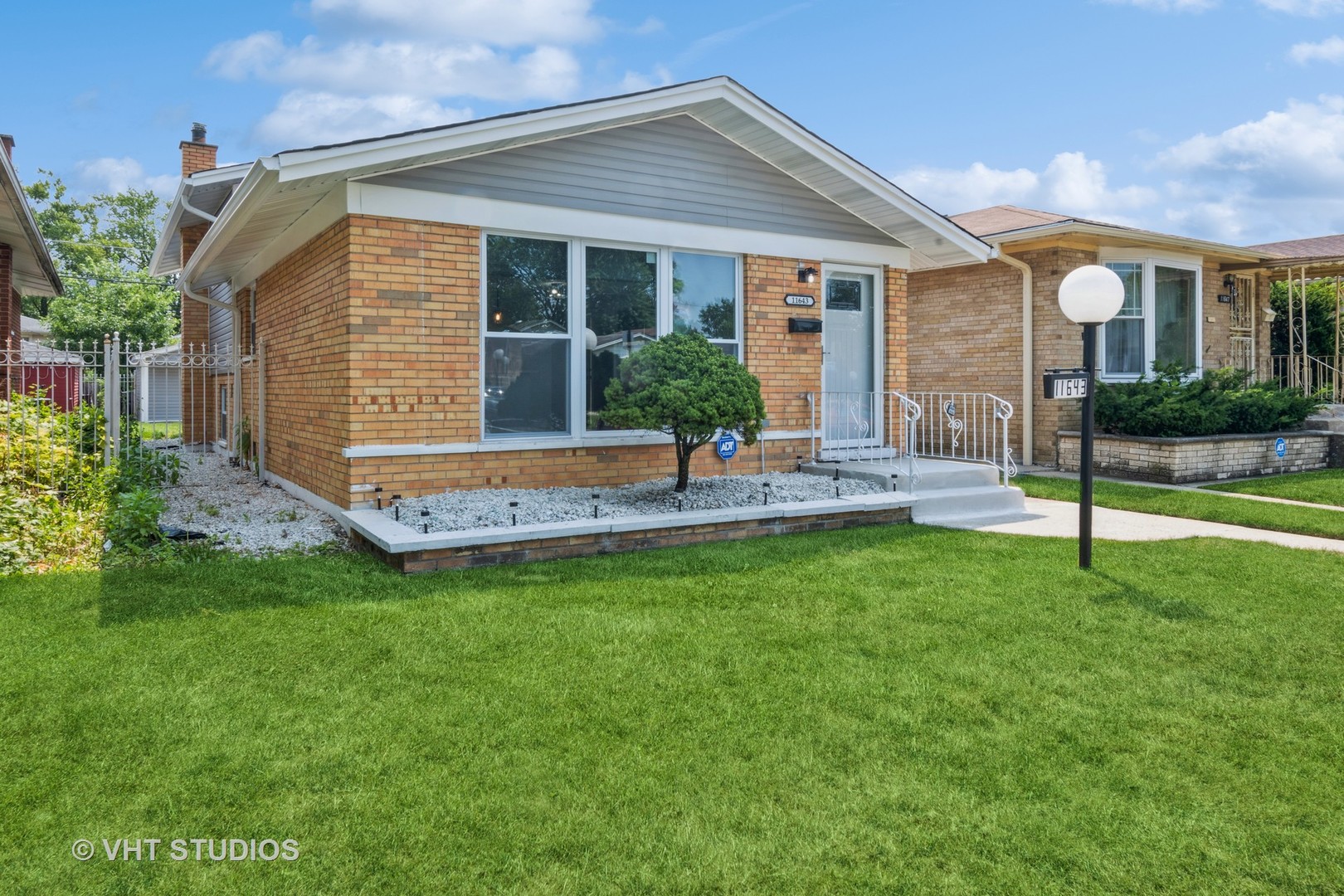 a view of a house with a backyard and a patio