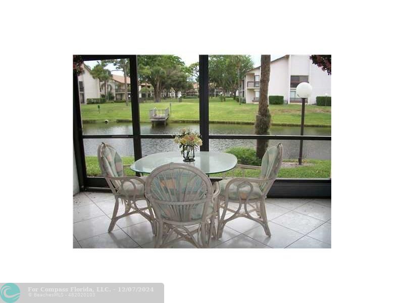 a dining room with furniture and a floor to ceiling window