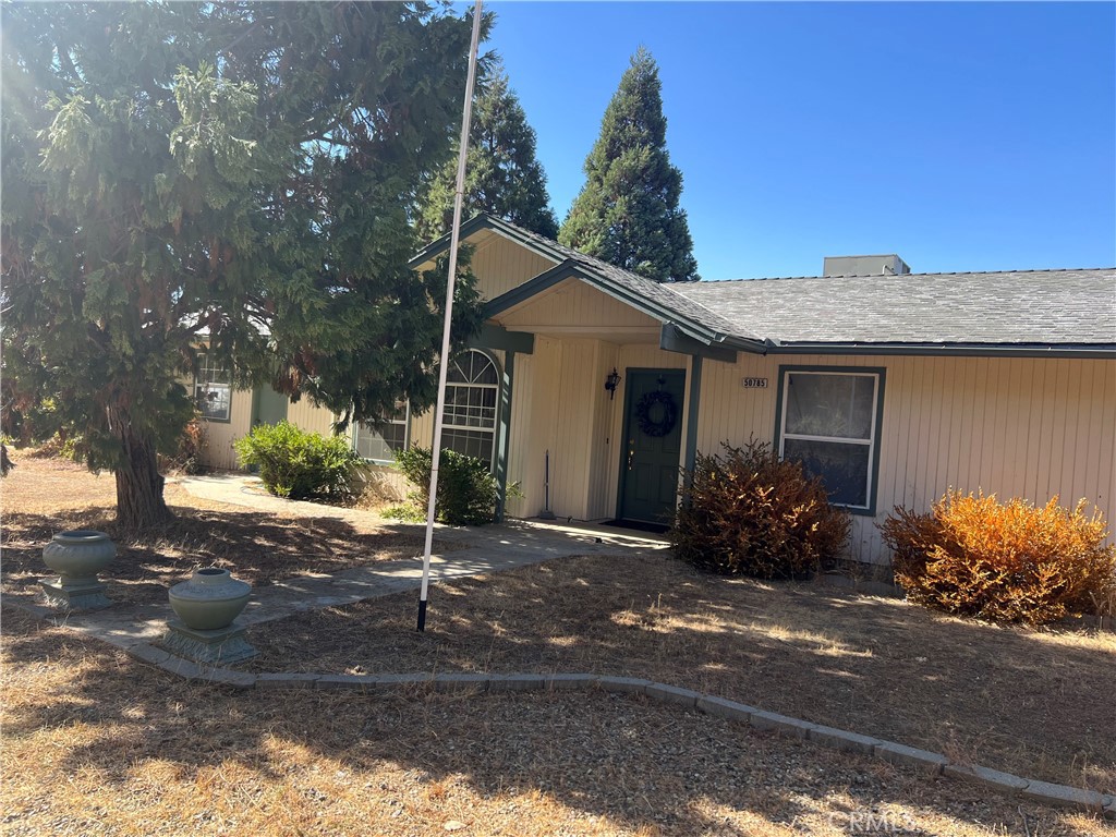 a front view of a house with a yard and outdoor seating