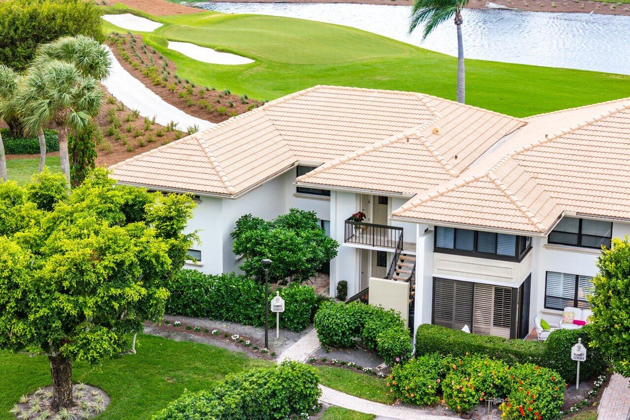 a view of a white house with a yard