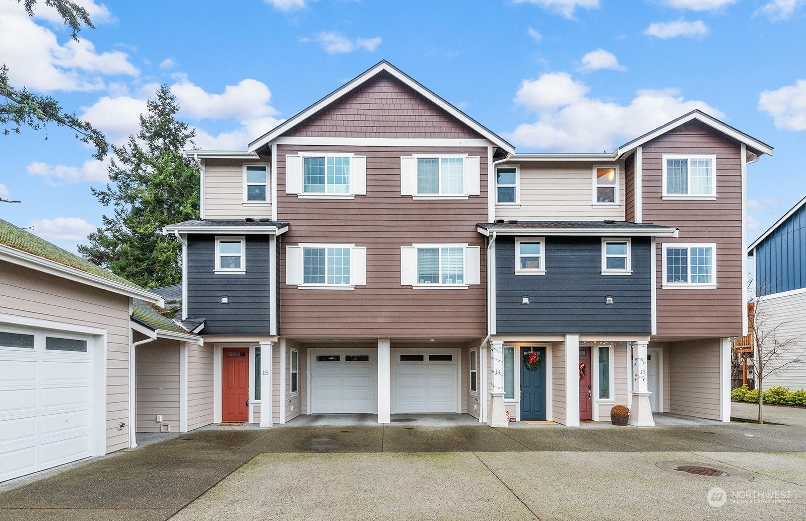 a front view of a house with yard and parking