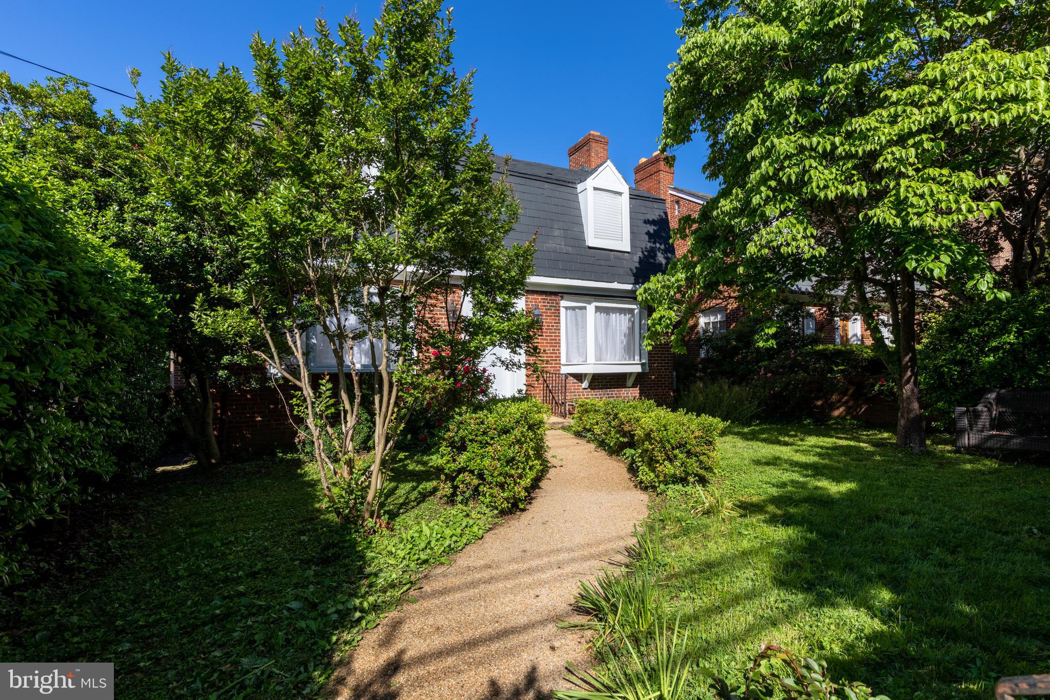 a view of a house with a yard and garden