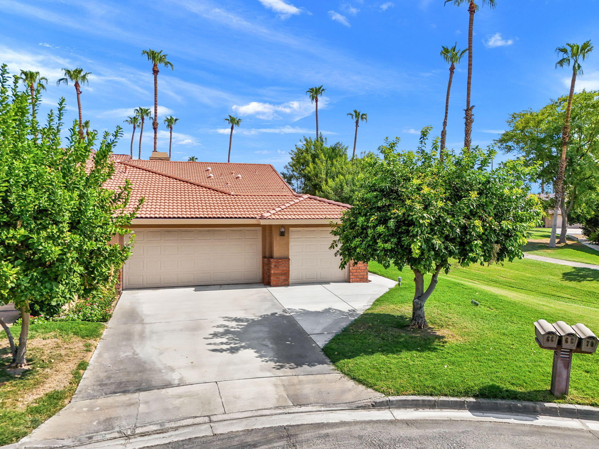 a front view of a house with a yard and trees