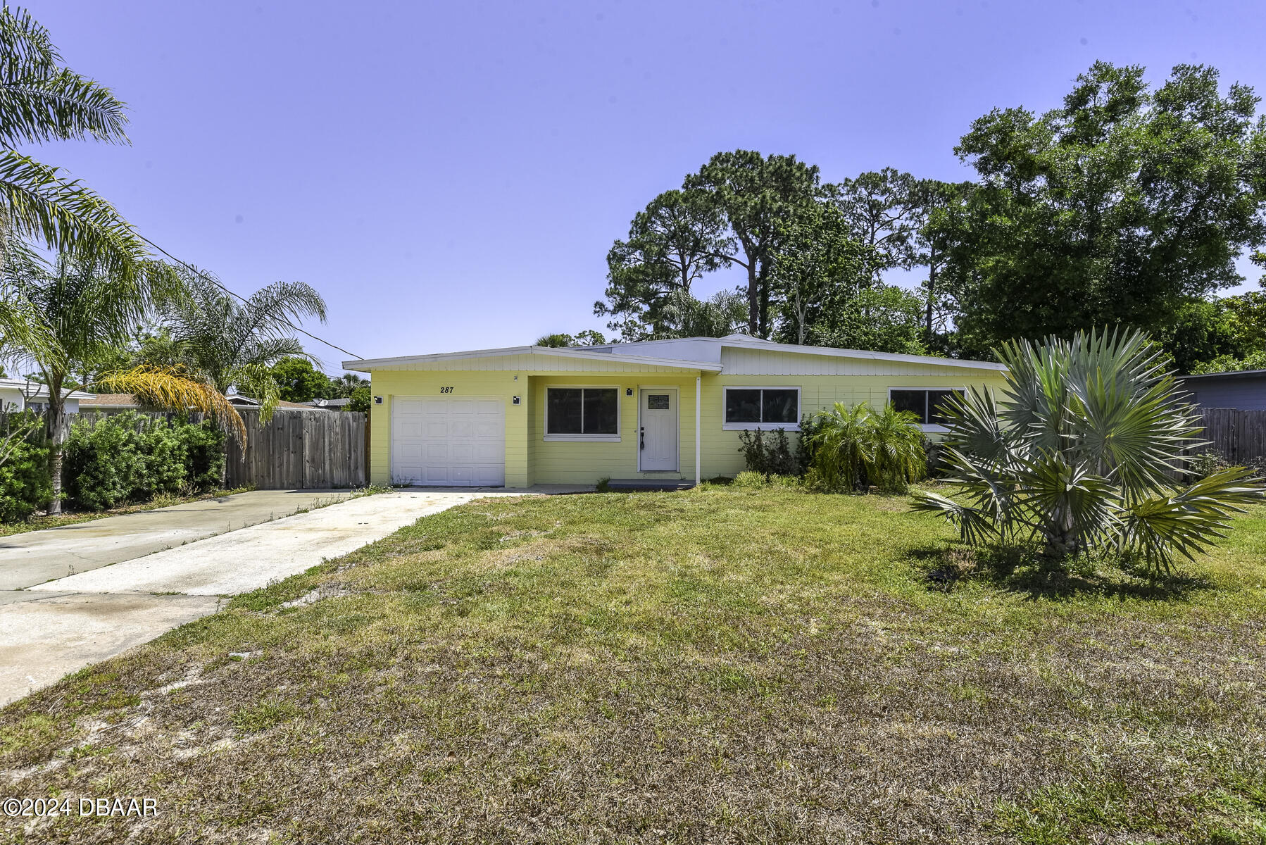 a view of a house with a backyard