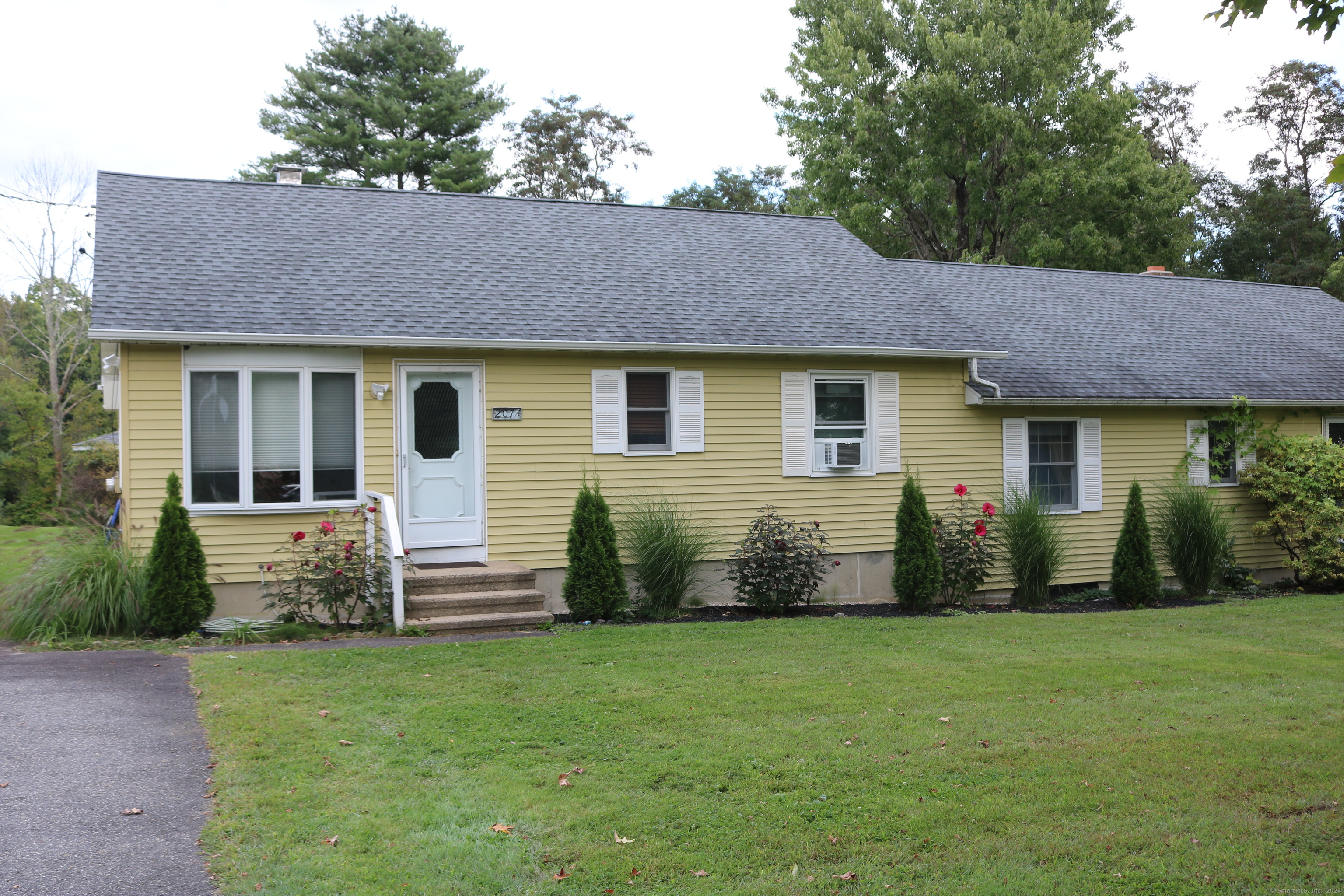 a front view of house with yard and outdoor seating