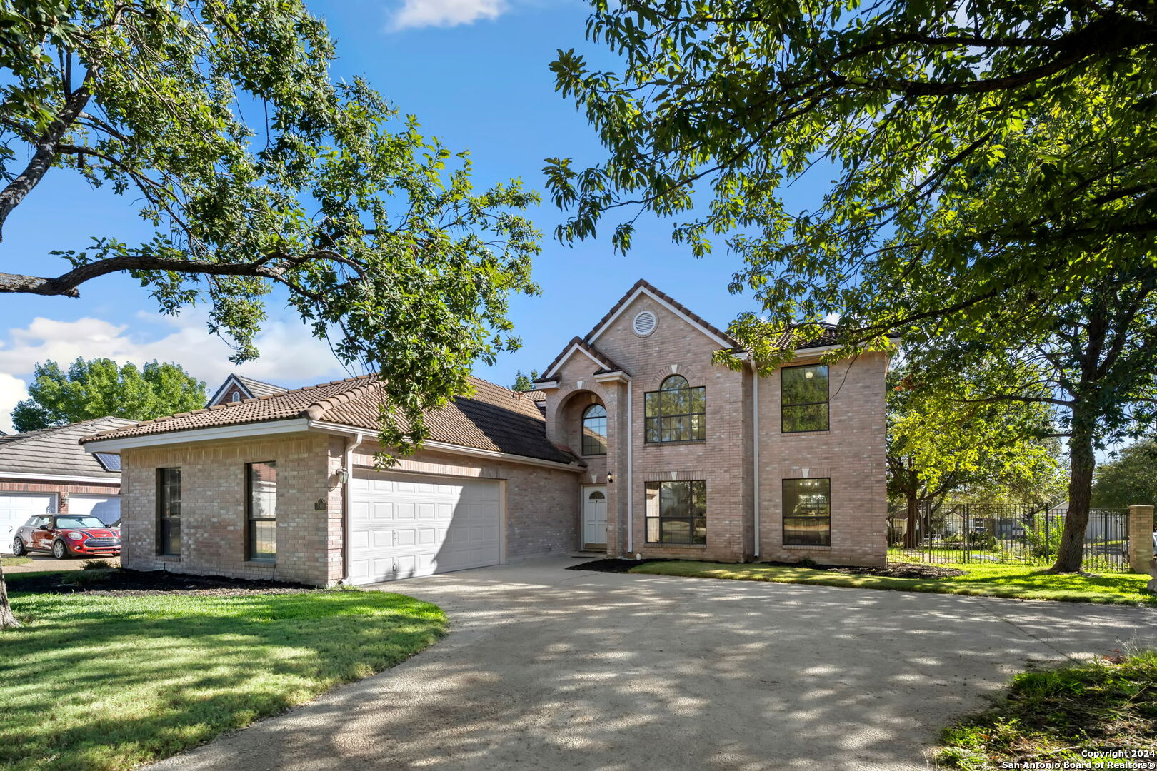 a front view of a house with a yard and garage