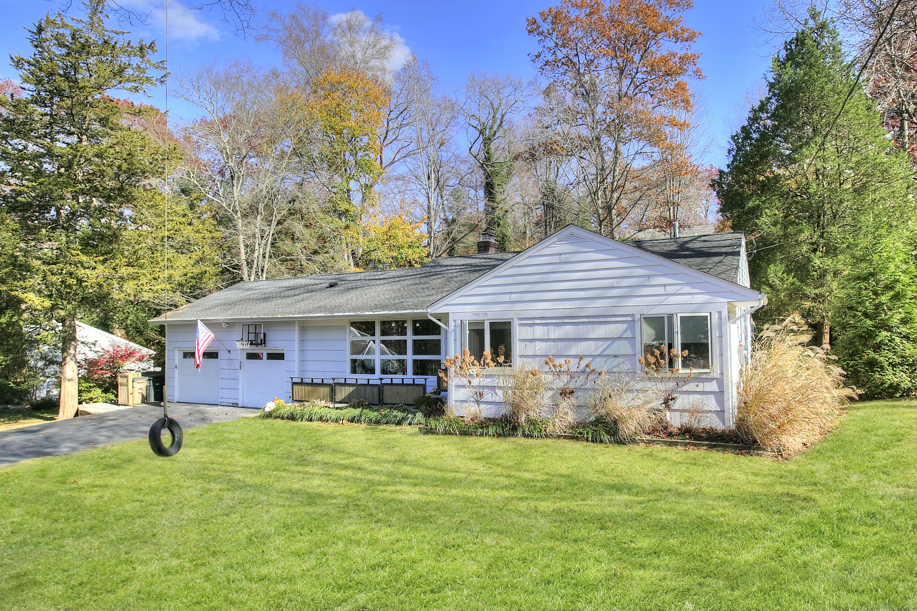 a front view of house with yard and green space