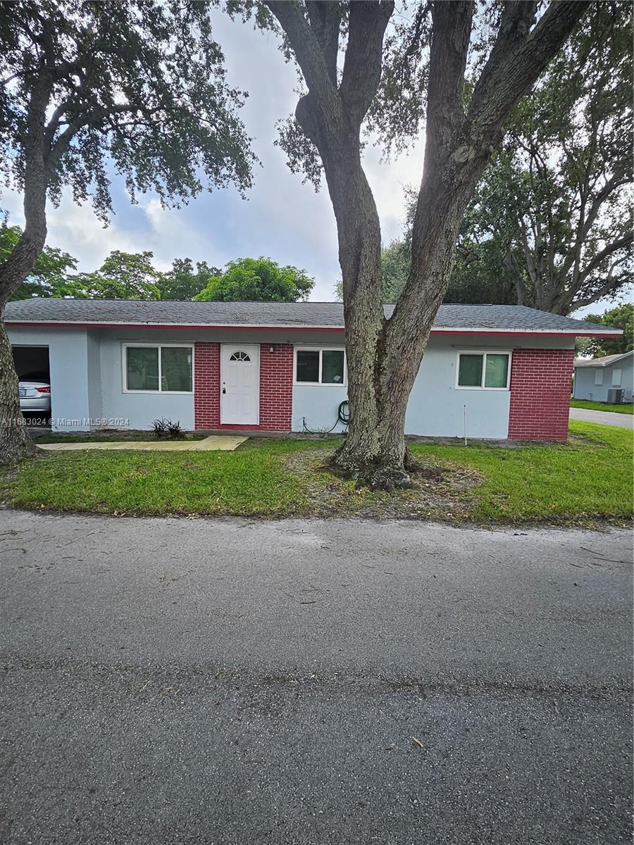 a front view of house with yard and trees