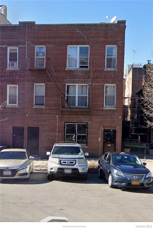 a car parked in front of a brick building