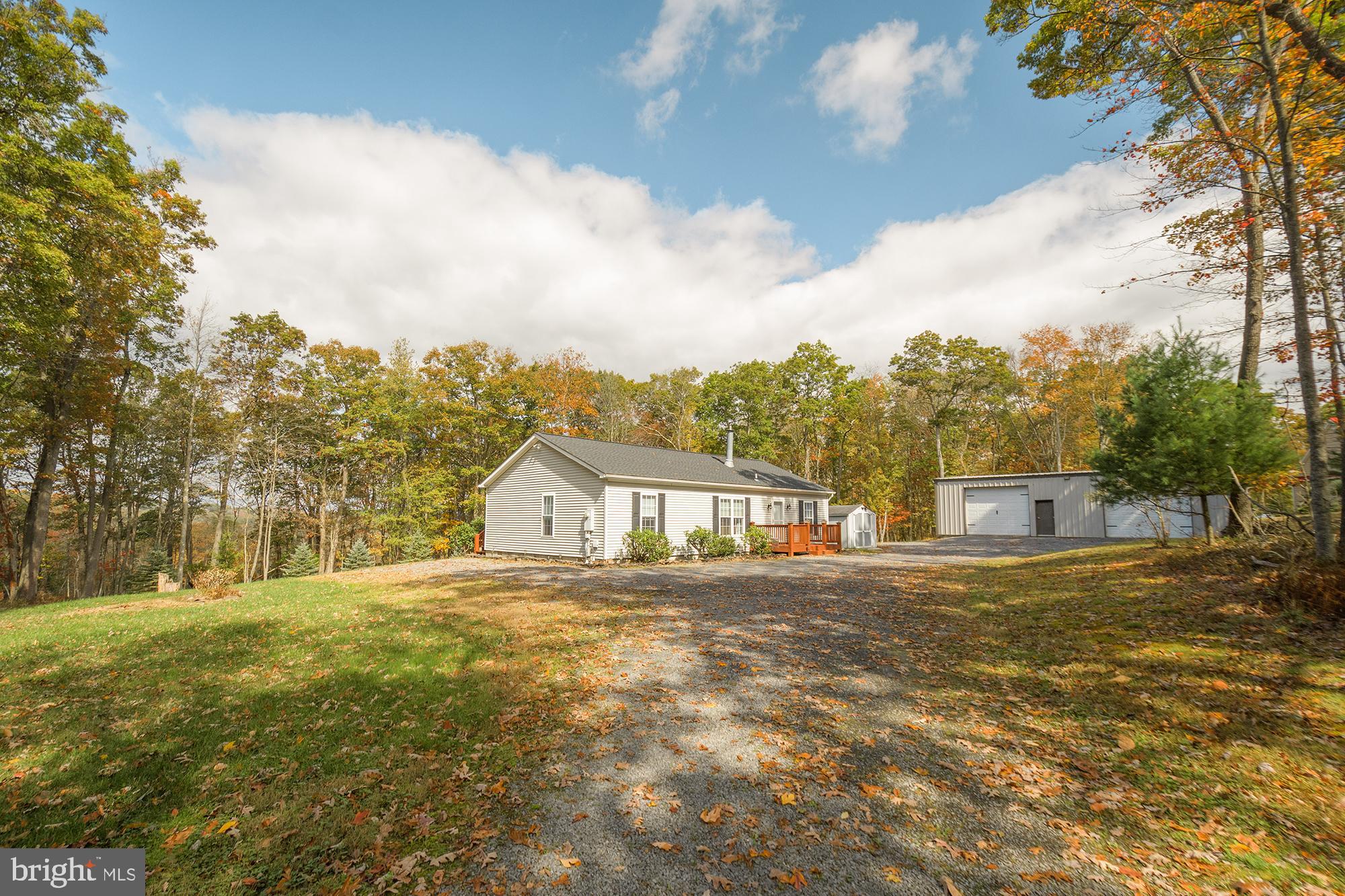 a view of an house with backyard and trees