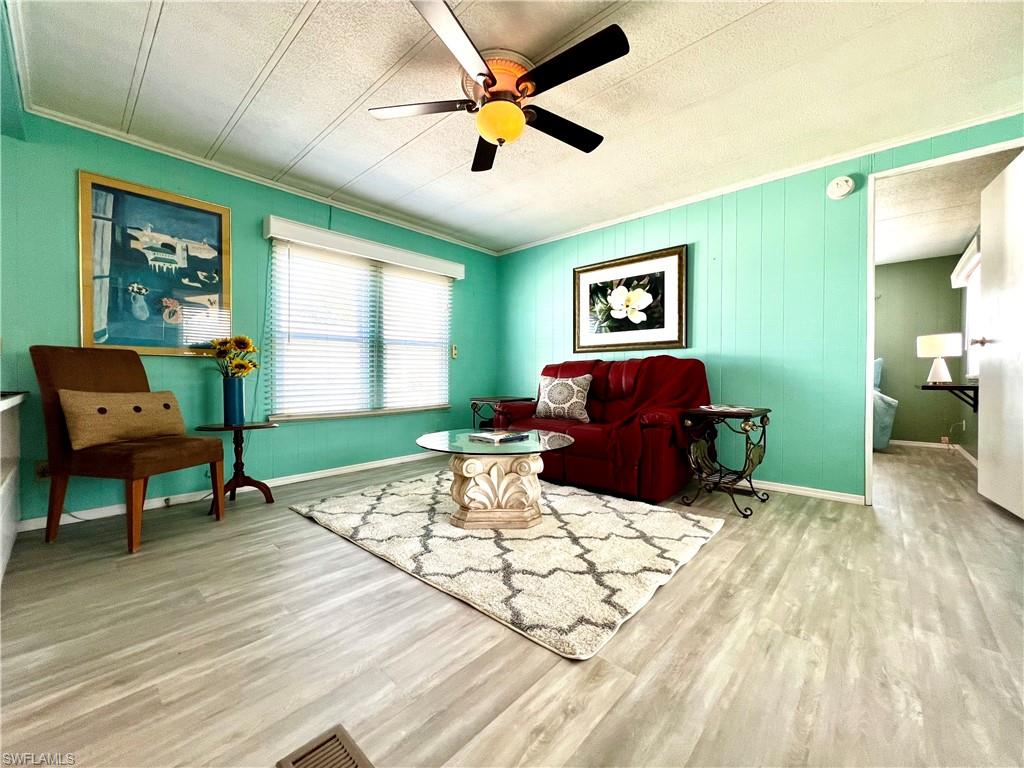 a living room with furniture a window and a flat screen tv