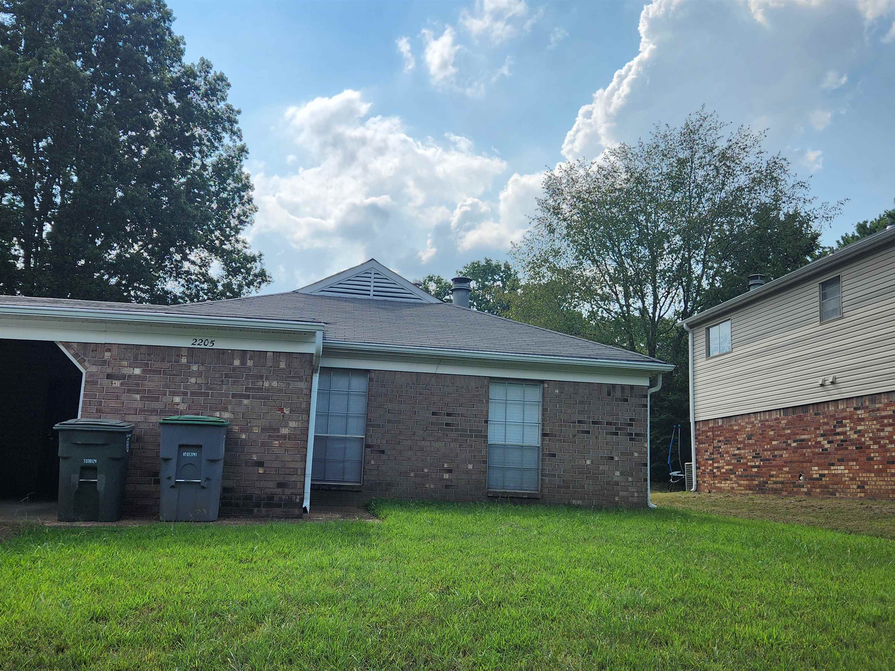 Back of house featuring a yard