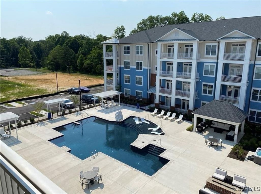 View of pool featuring a gazebo and a patio area