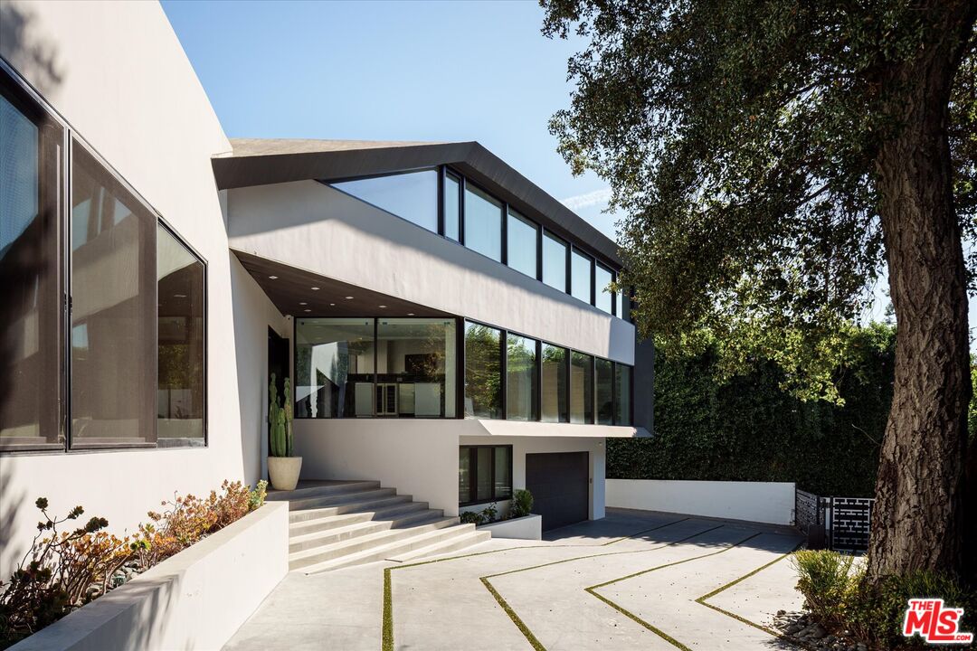 a view of a house with a outdoor sitting area